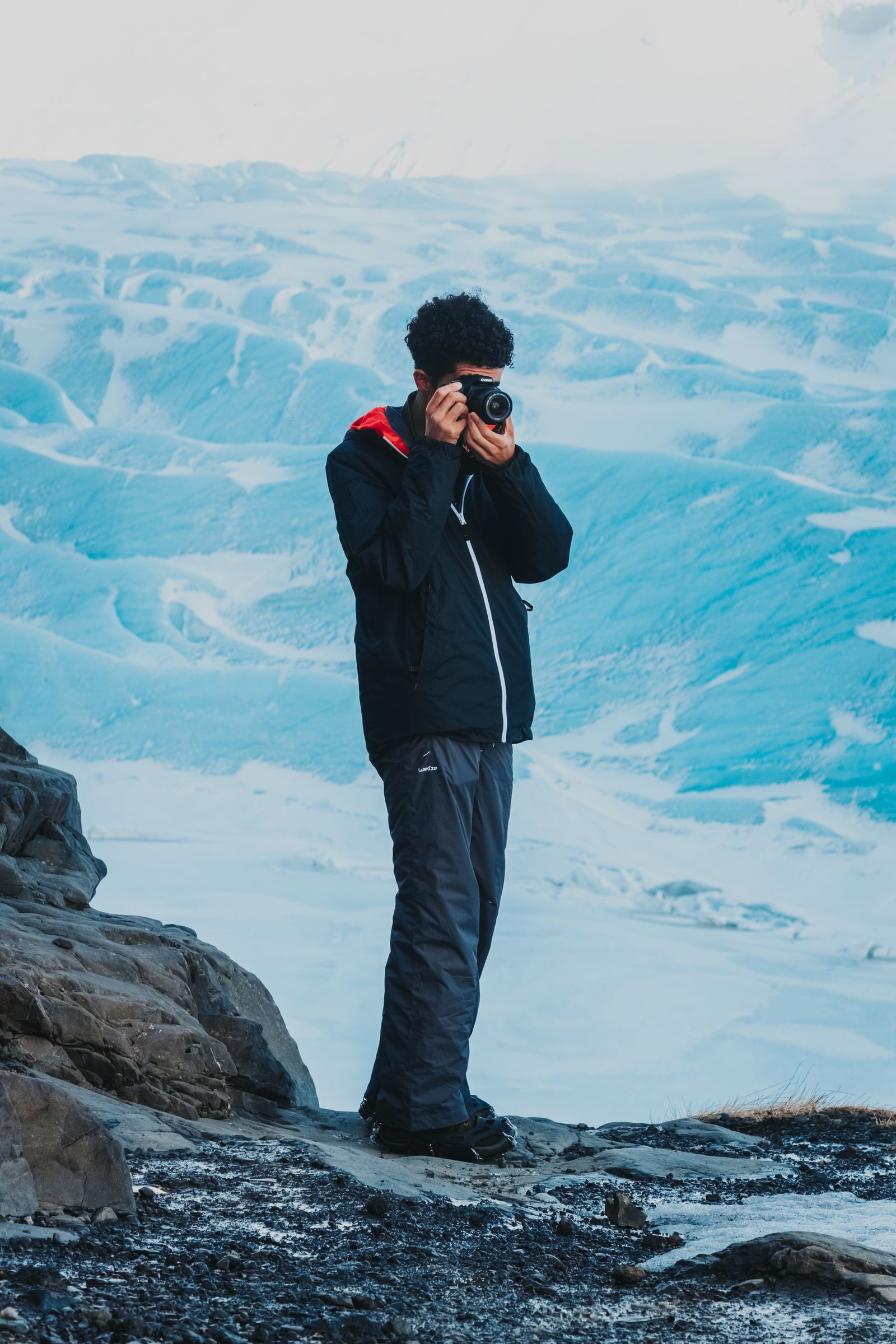 Traveller photographing a snowy landscape