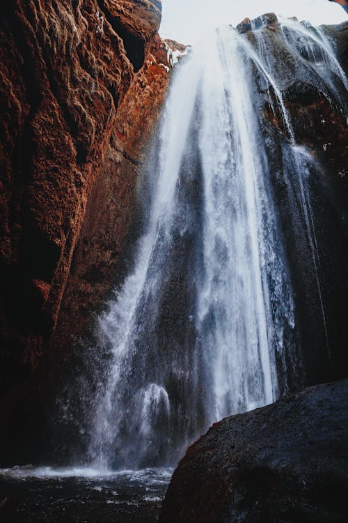Mountain waterfall in rocky ravine