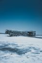 Old ruined aircraft after disaster on snowy terrain under blue sky in winter