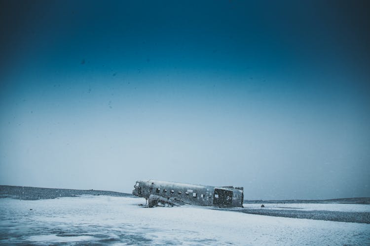 Old Airplane After Disaster On Snowy Land Near Mounts