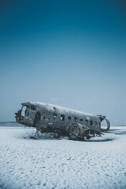 Crashed aircraft after disaster on snowy land under sky · Free