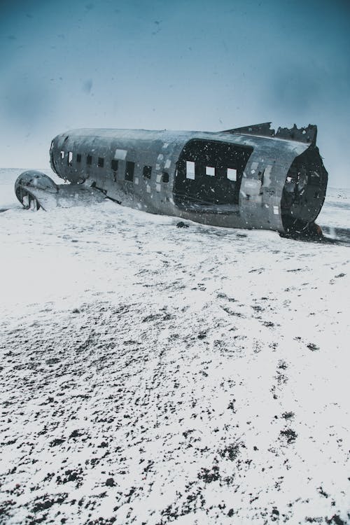 Aged aircraft after accident on uneven snowy land