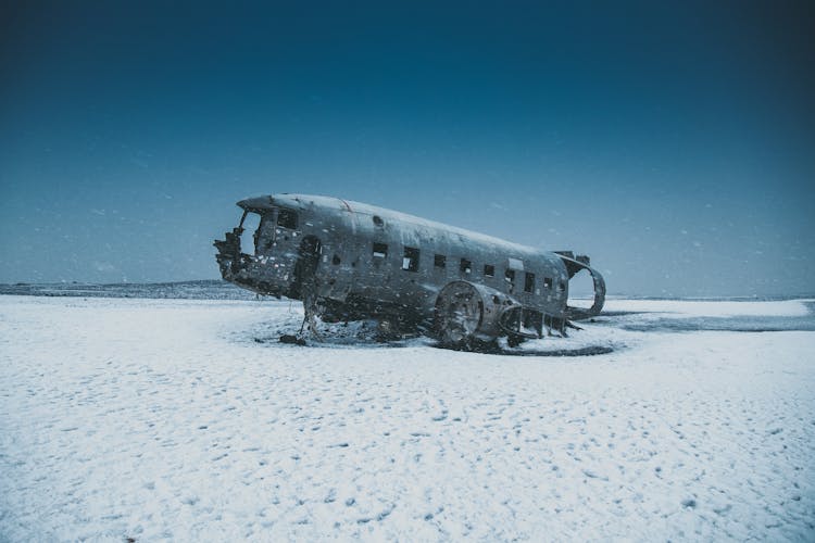 Aged Plane Cabin After Accident On Snowy Land Behind Mountains