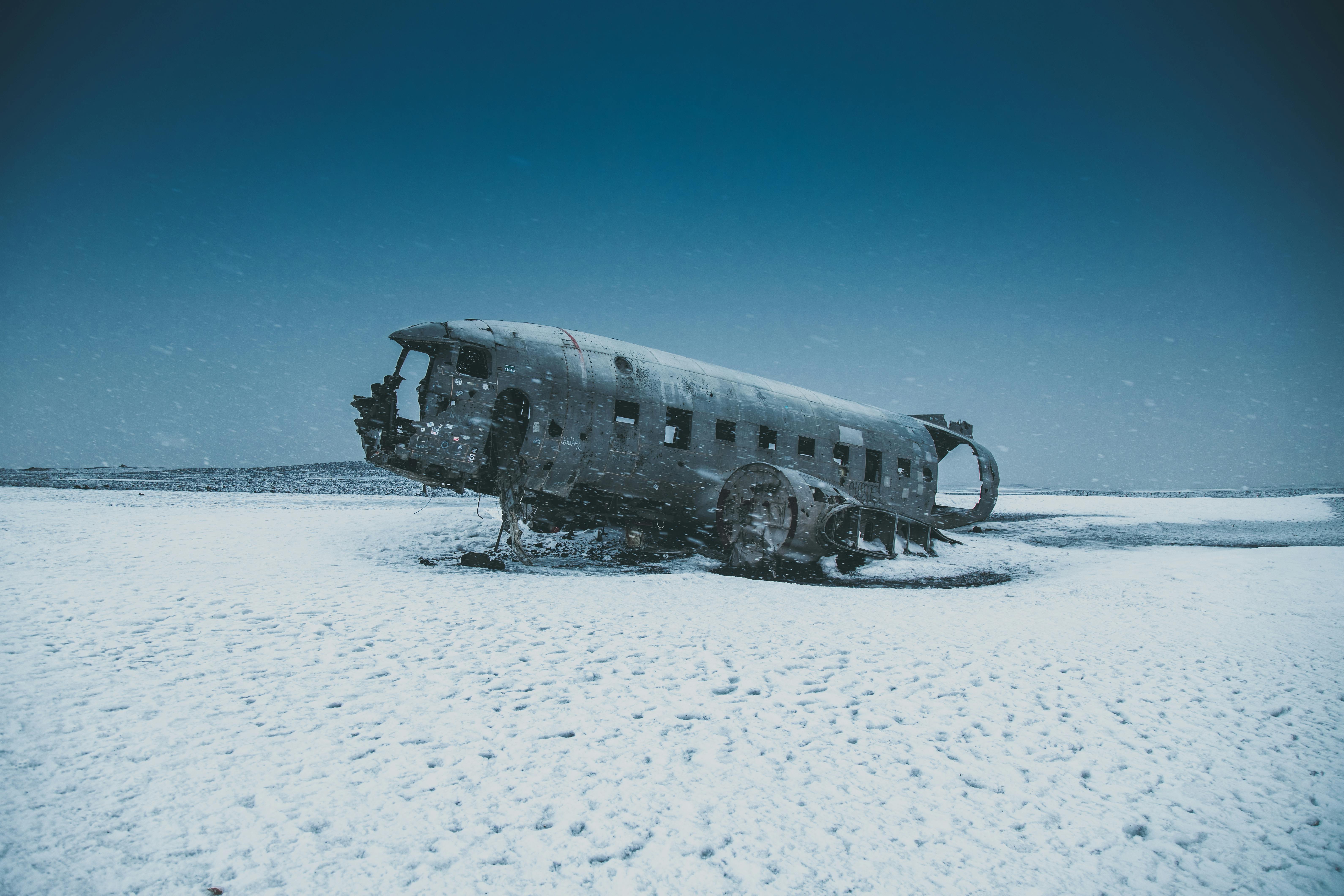Crashed aircraft after disaster on snowy land under sky · Free Stock Photo