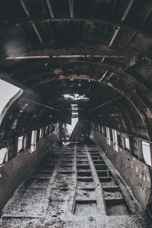 Free Black and white of aged abandoned aircraft cabin with rough floor and weathered ceiling after disaster Stock Photo