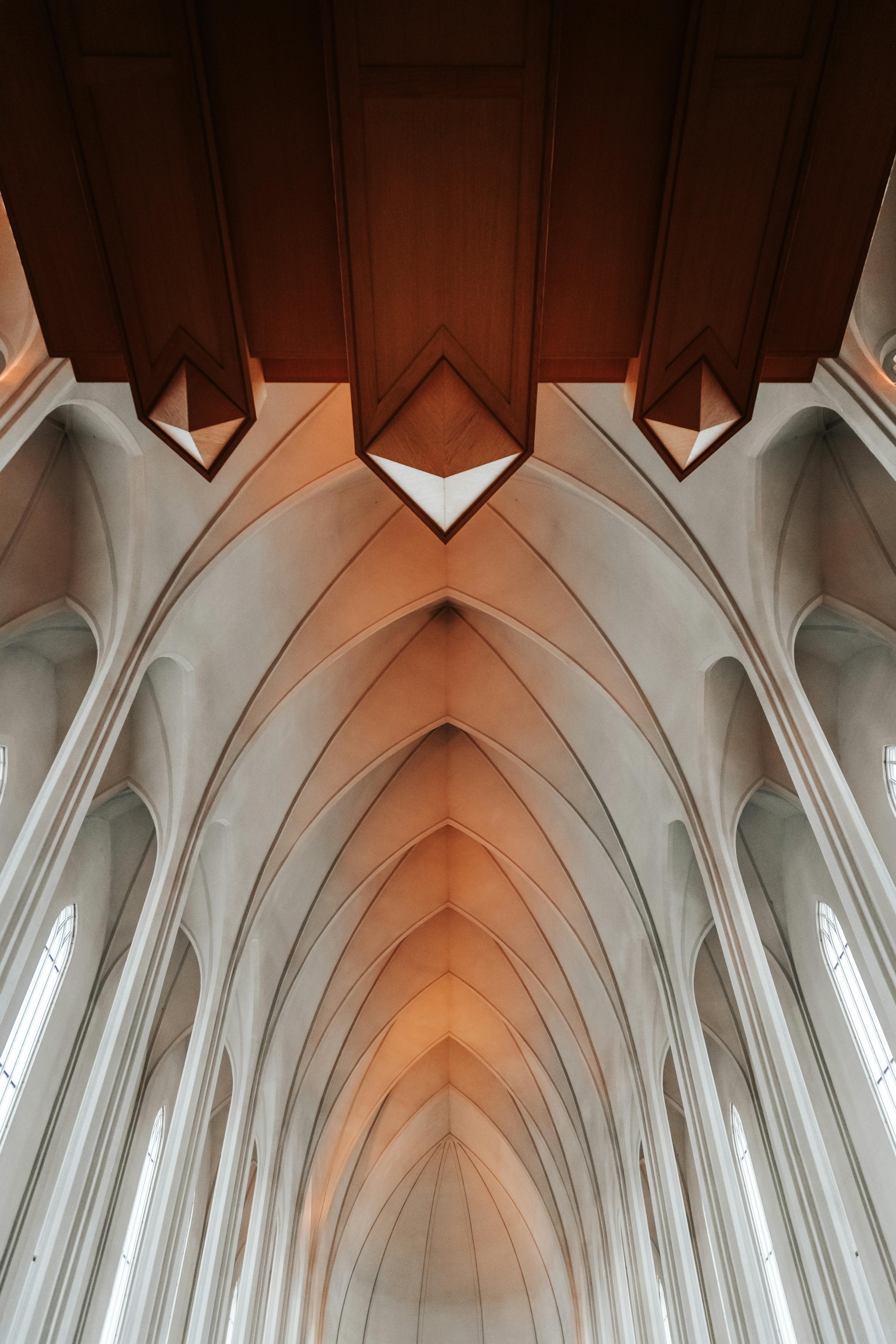 Aged cathedral interior with arched vault in daylight