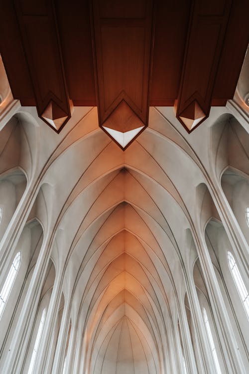 Aged cathedral interior with arched vault in daylight