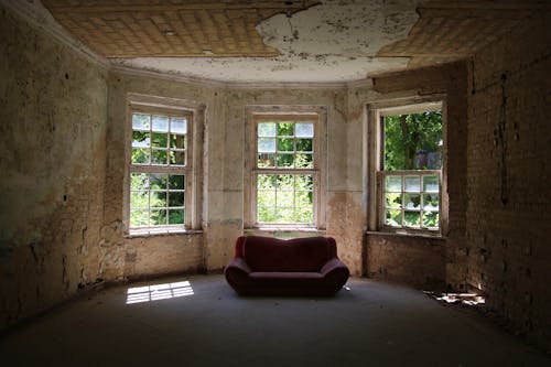 A Red Leather Sofa Near Window