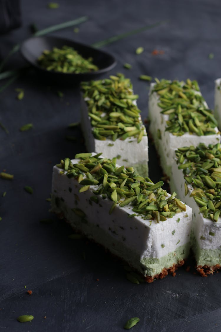 Tasty Pastries With Green Pistachios On Top On Table