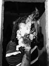 Unrecognizable black man smoking on city street