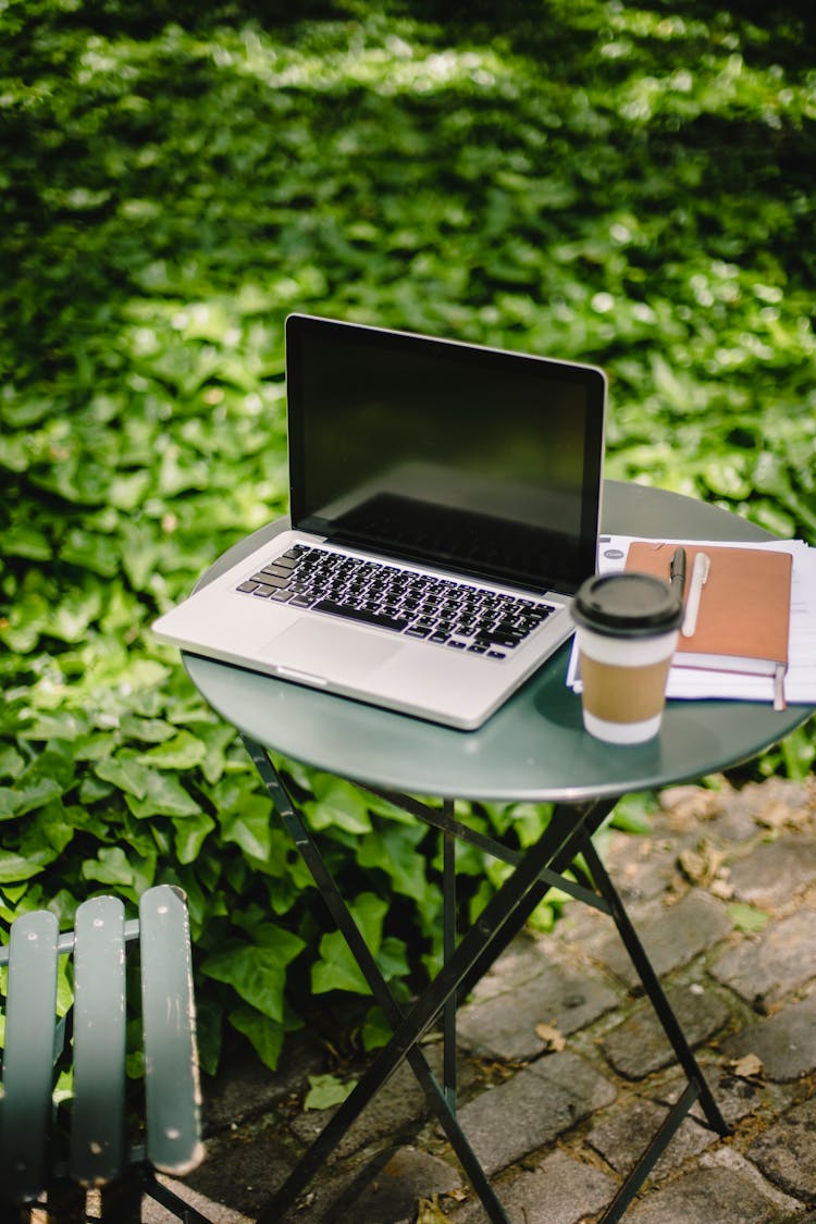 Round Table With Laptop Notebook And Takeaway Coffee