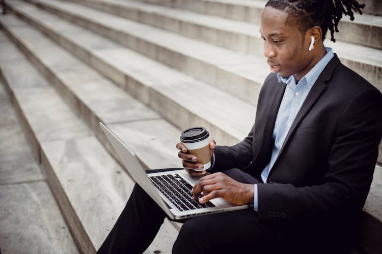 Crop Content Black Businessman Typing On Laptop On Stone Stairs