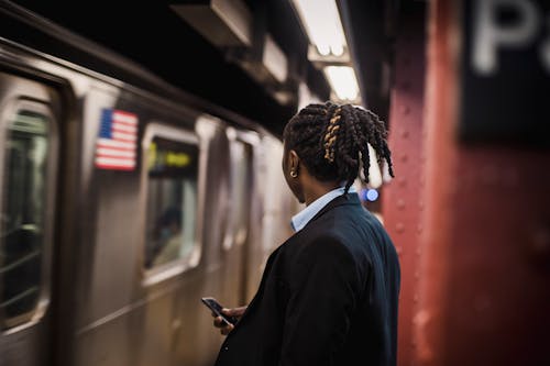 Man in suit looking at arriving train on subway