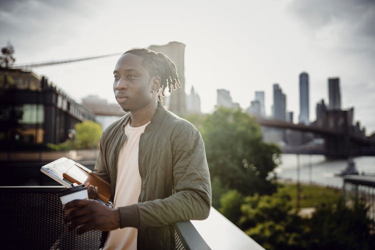 Serious Black Student With Notebooks And Coffee