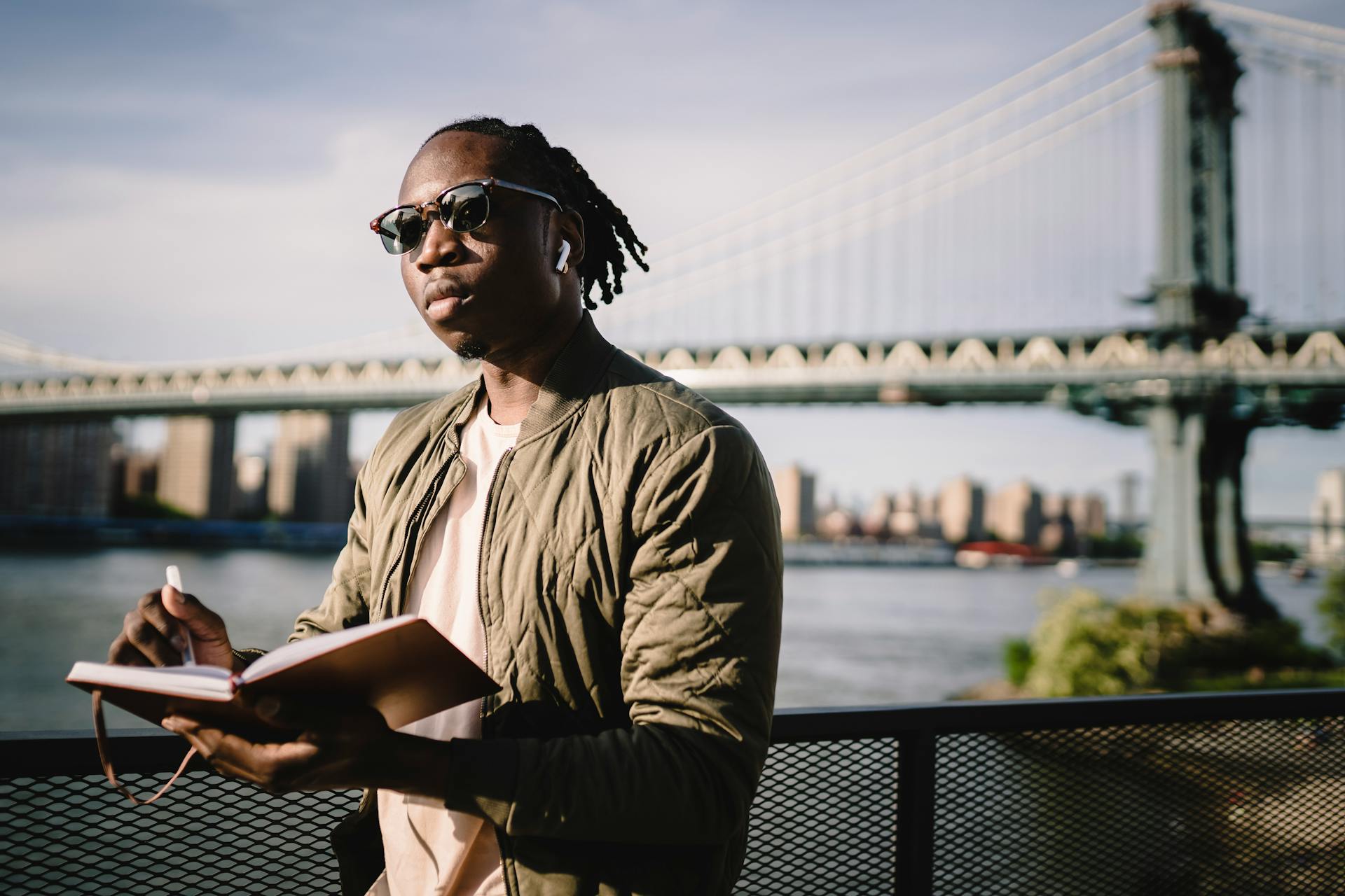 Focused black man searching location standing on river embankment