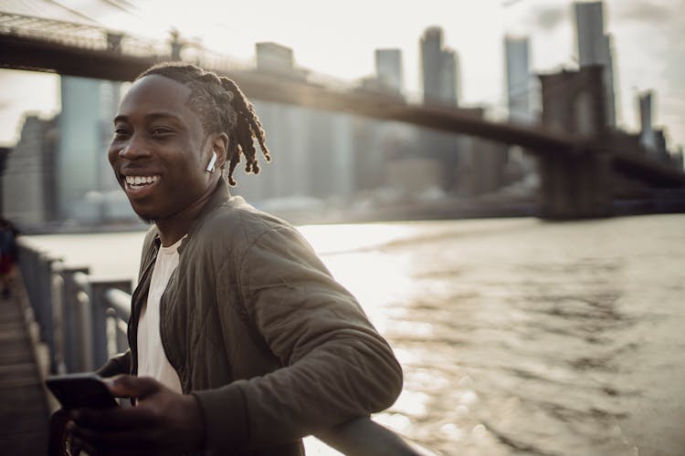 Cheerful Black Man Spending Day Outdoors On Quay