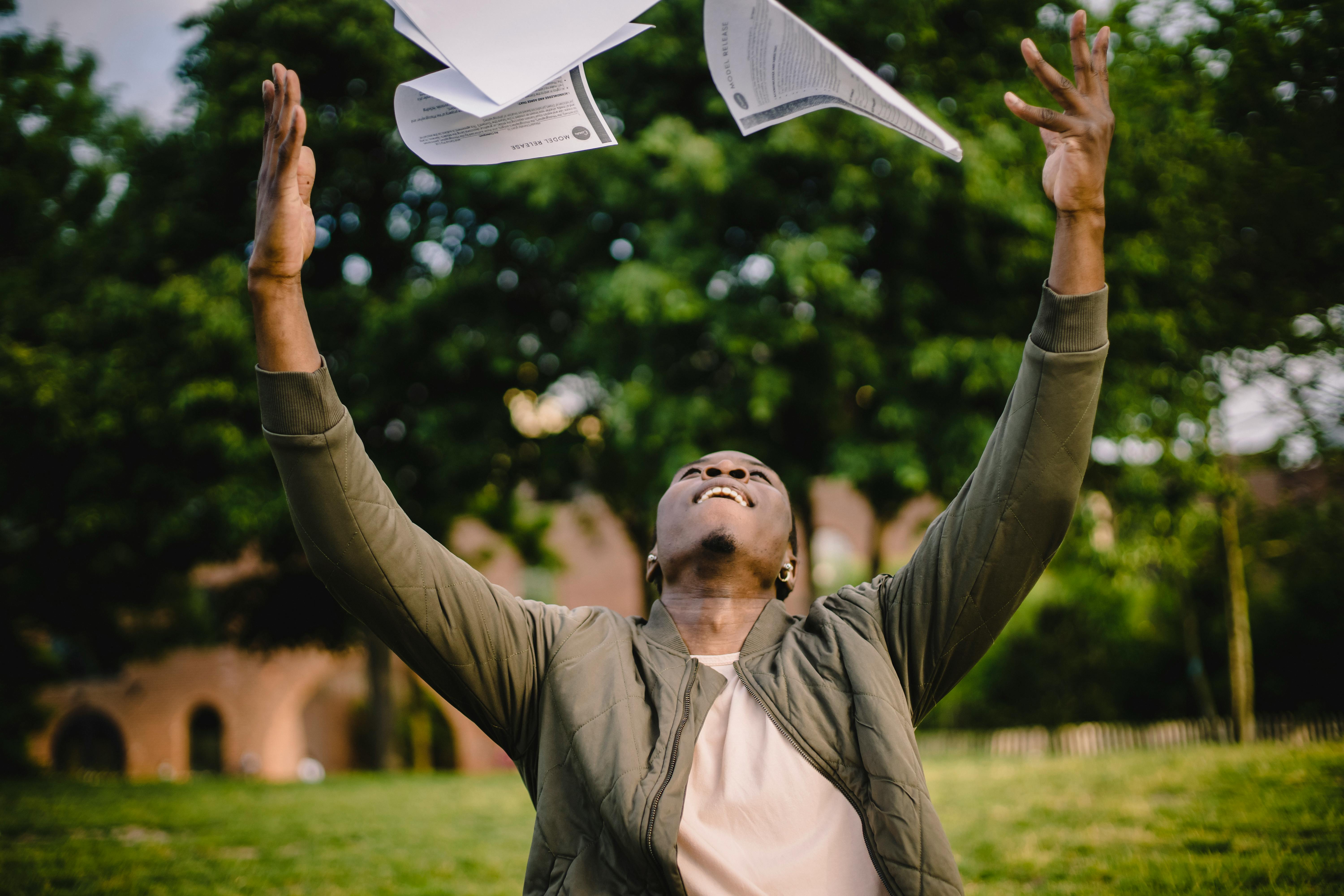 overjoyed employee throwing papers in air after completing paperwork