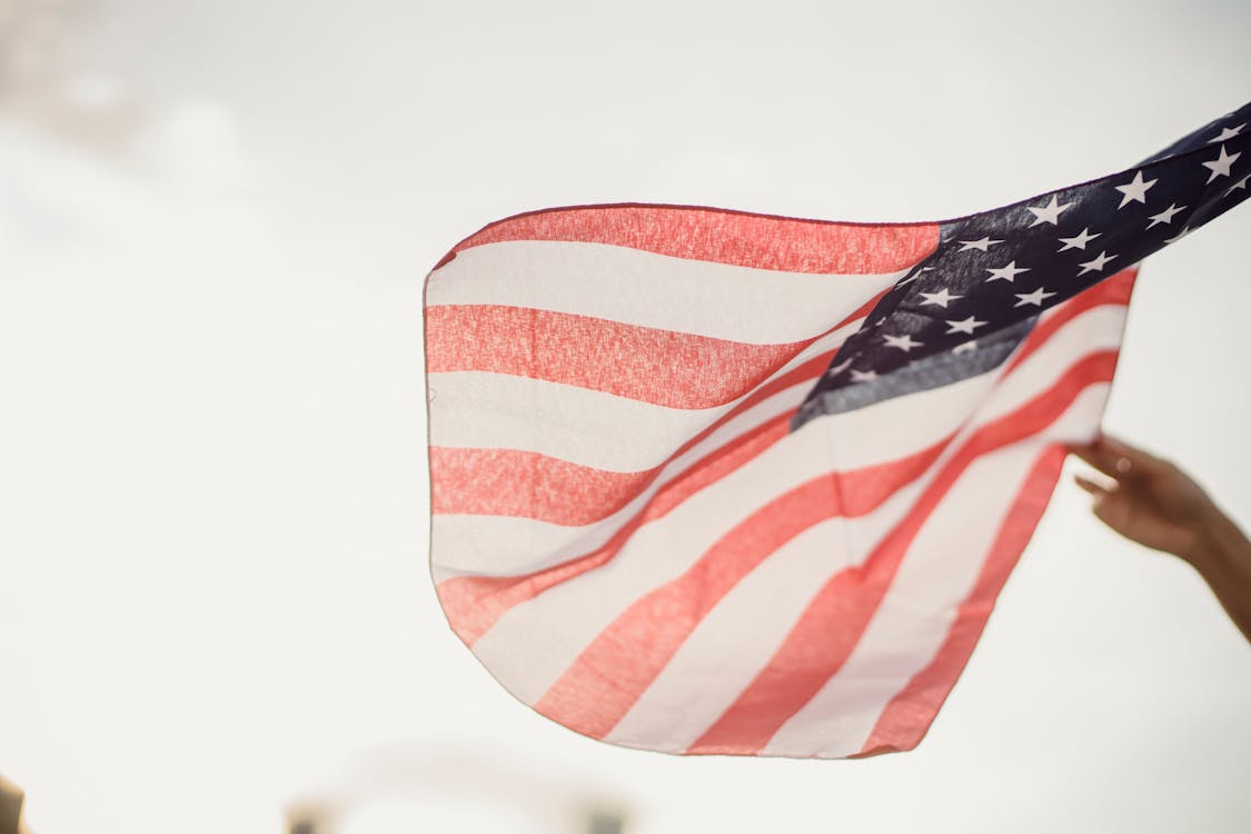 Free Person Holding An American Flag Stock Photo