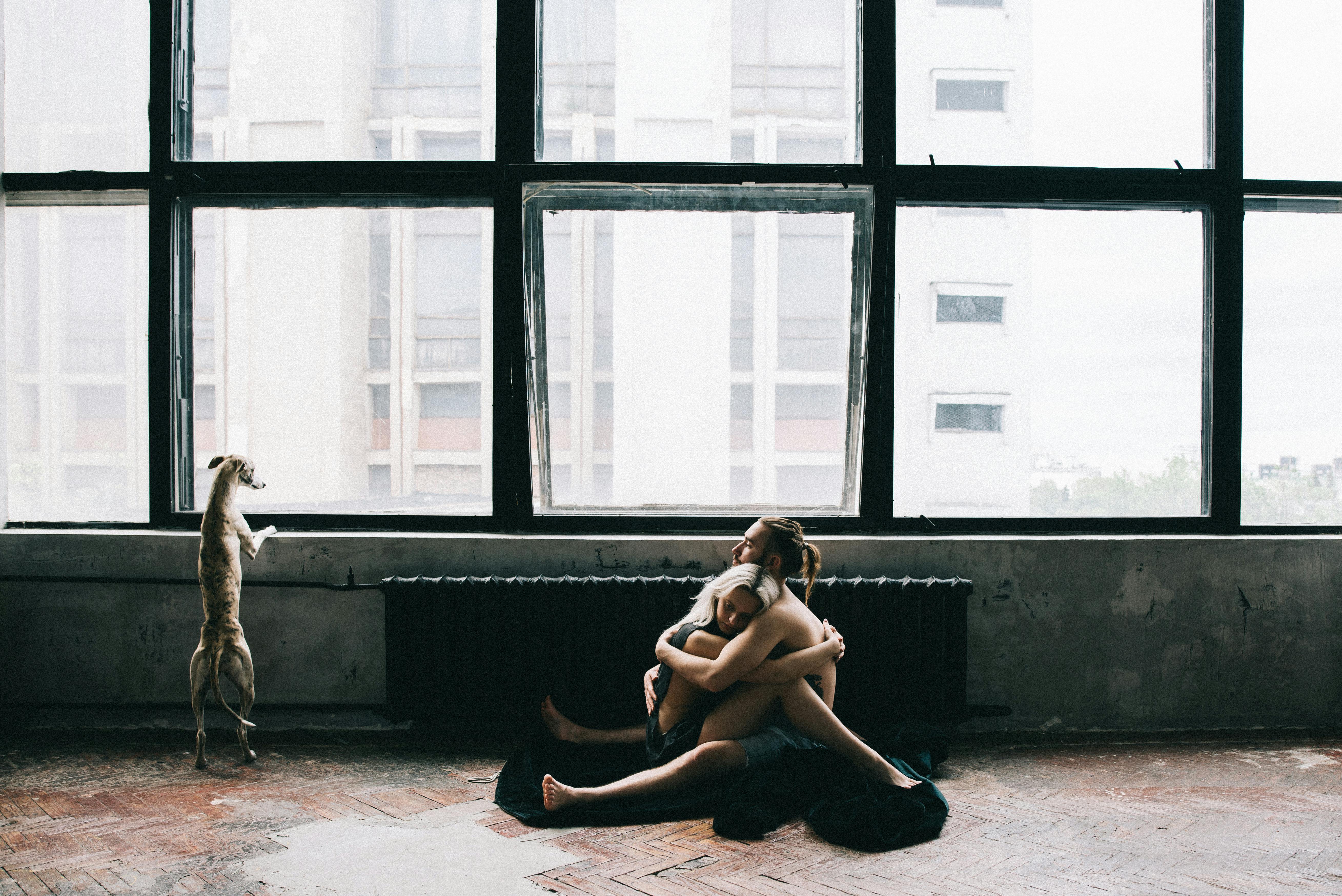 couple sitting on the floor and hugging