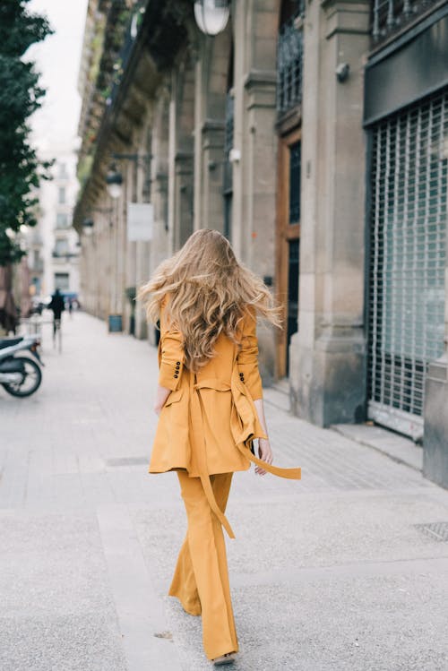 Back View of a Woman in a Yellow Coat