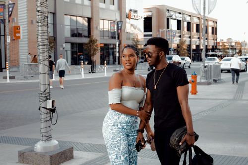 Free Young couple in urban fashion walking downtown in Canada during the day. Stock Photo
