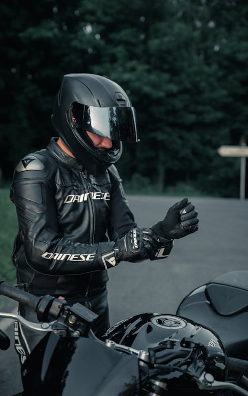 Man in Black Leather Jacket and Helmet