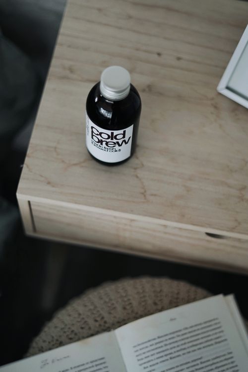 Free A close-up of a cold brew coffee bottle on a wooden surface, perfect for product shots. Stock Photo
