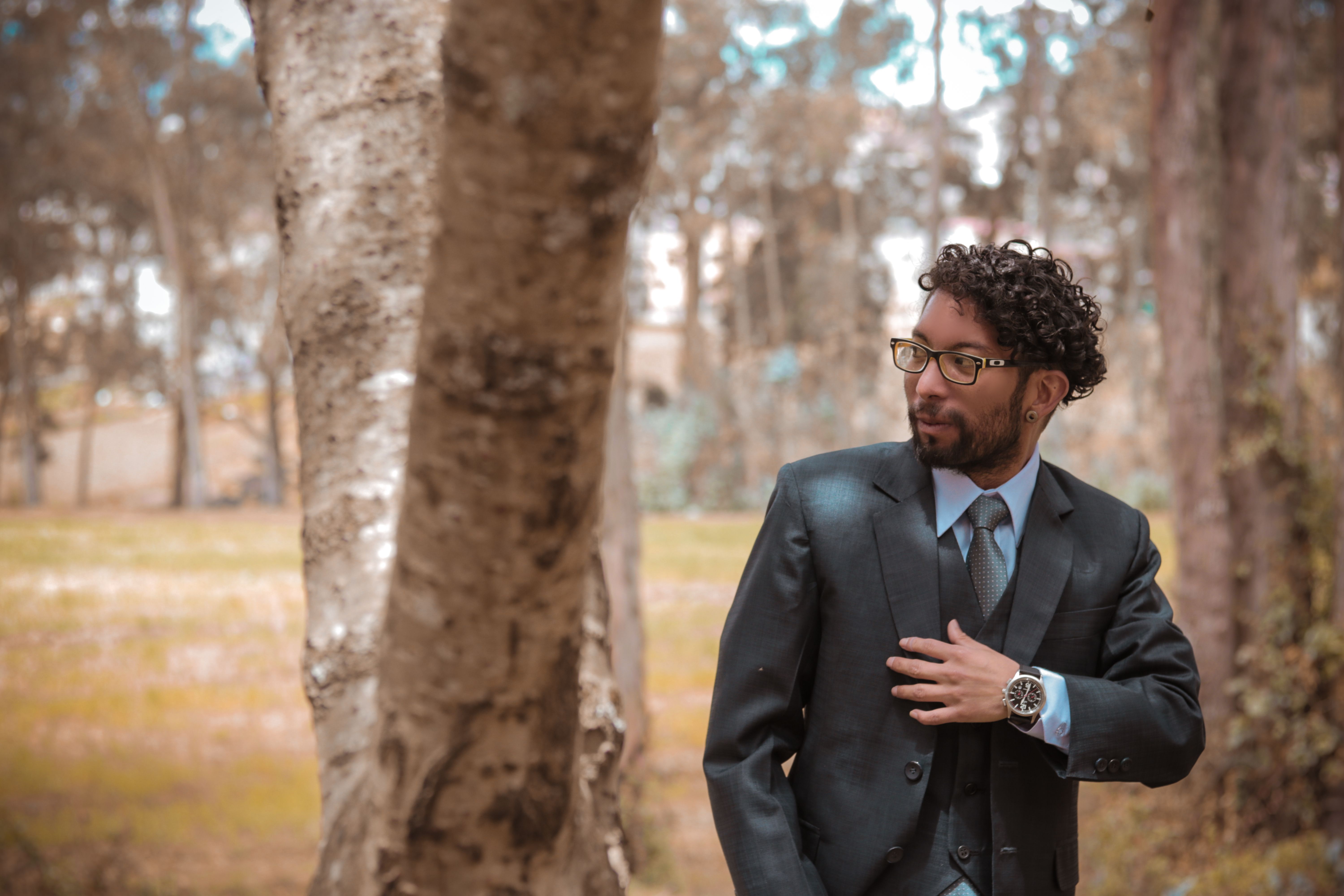 A Man in Black Suit Holding Bouquet of Colorful Flowers · Free Stock Photo