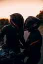 Man in Black and Red Motorcycle Suit Riding Motorcycle