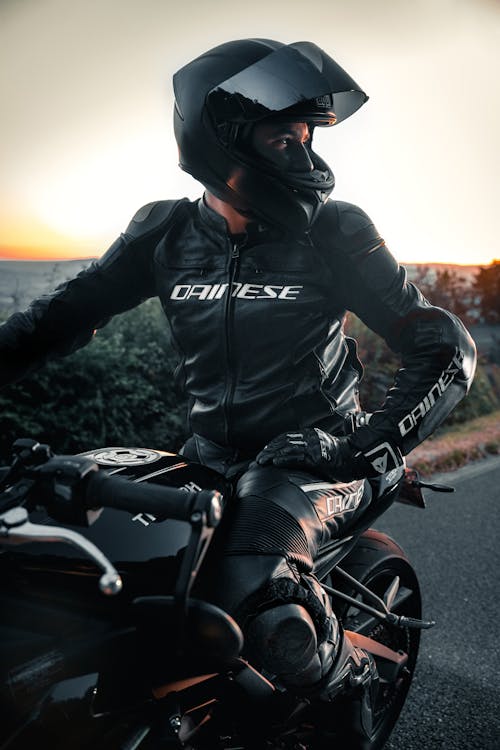 A Man in Black Leather Jacket Riding Motorcycle
