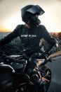 Man in Black Leather Jacket Riding Motorcycle