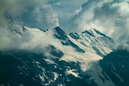 Free Majestic snow-covered peaks under a cloudy sky in Lauterbrunnen, Switzerland. Stock Photo
