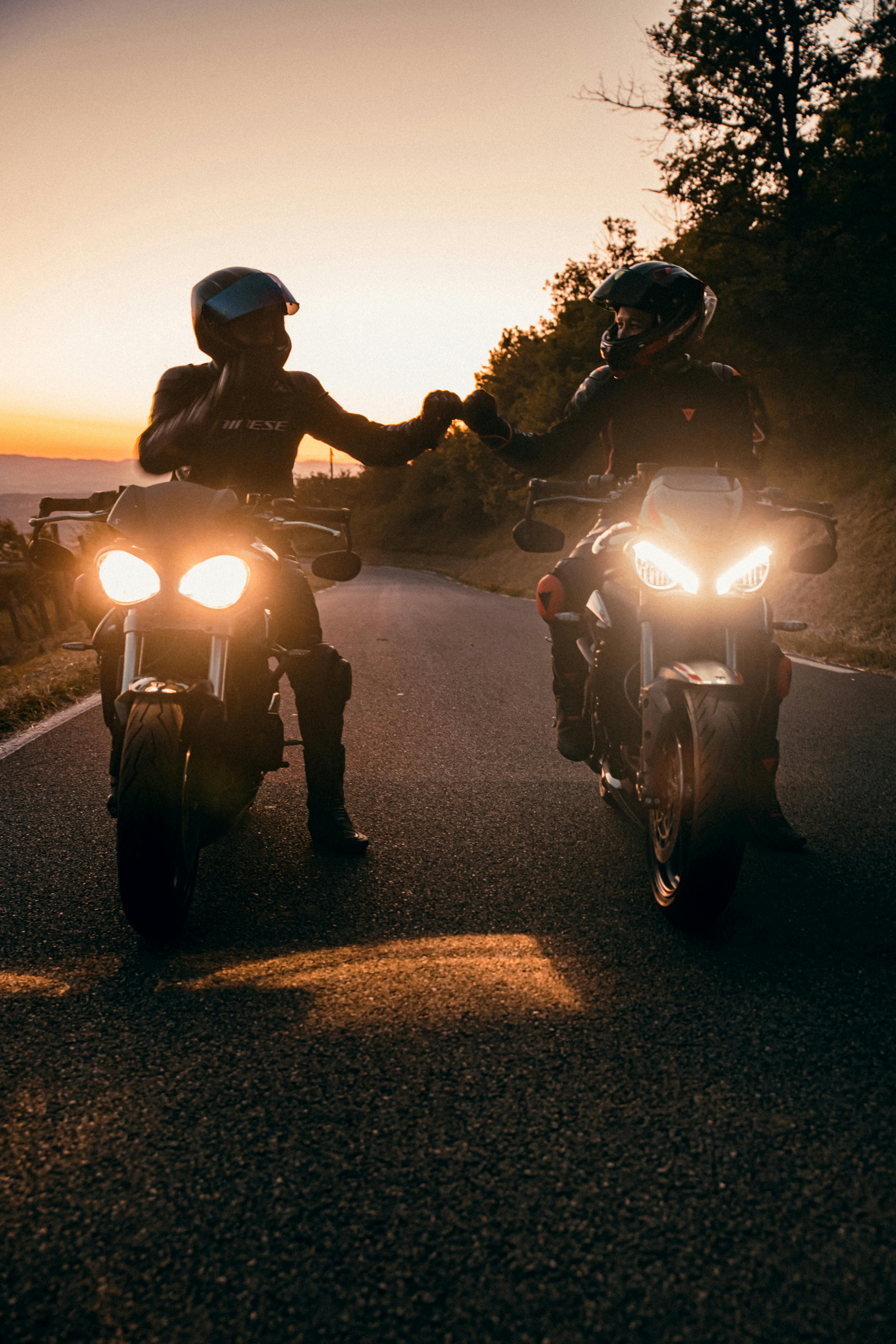 couple on motorcycle sunset