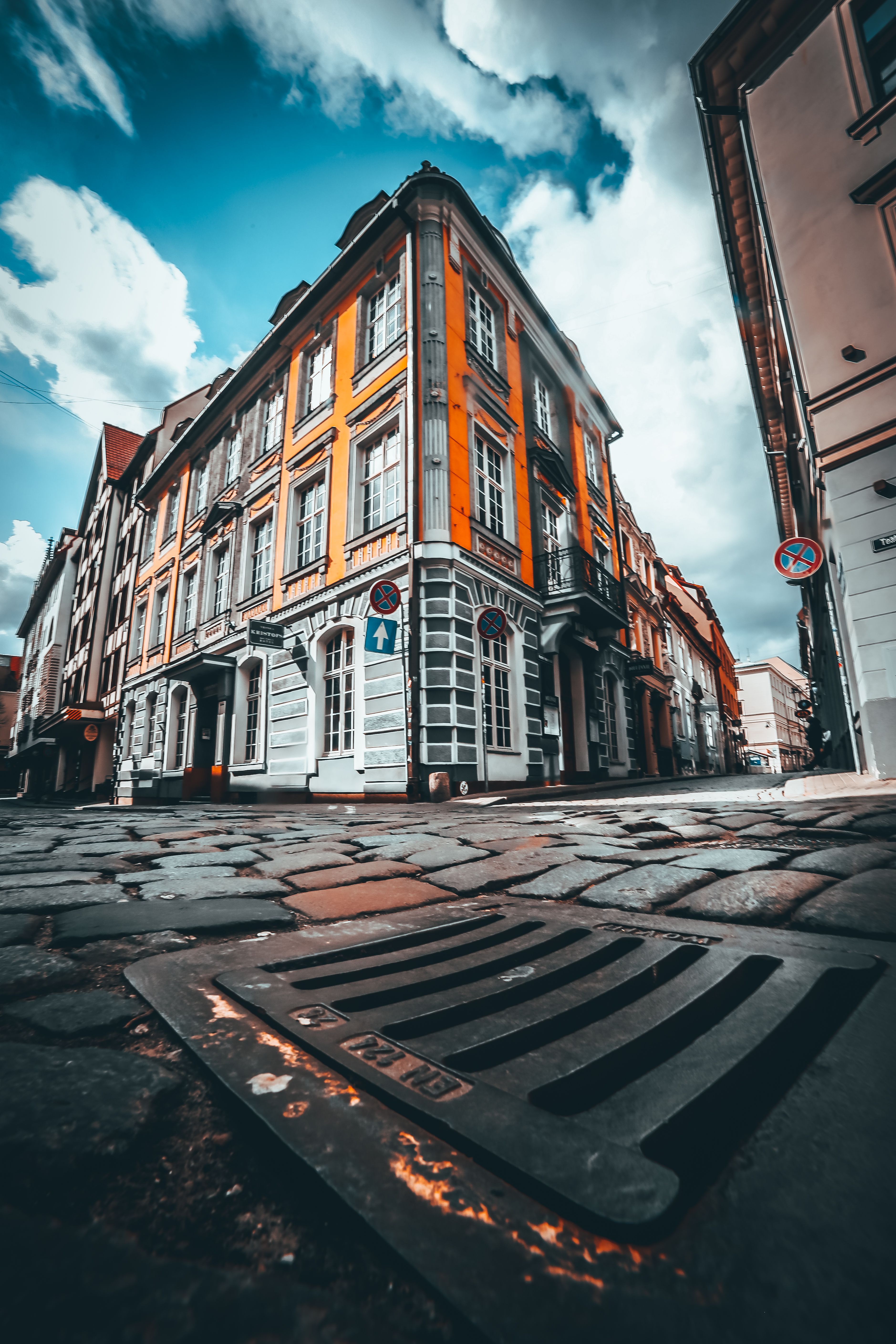 Old building facade on city street under cloudy sky · Free Stock Photo