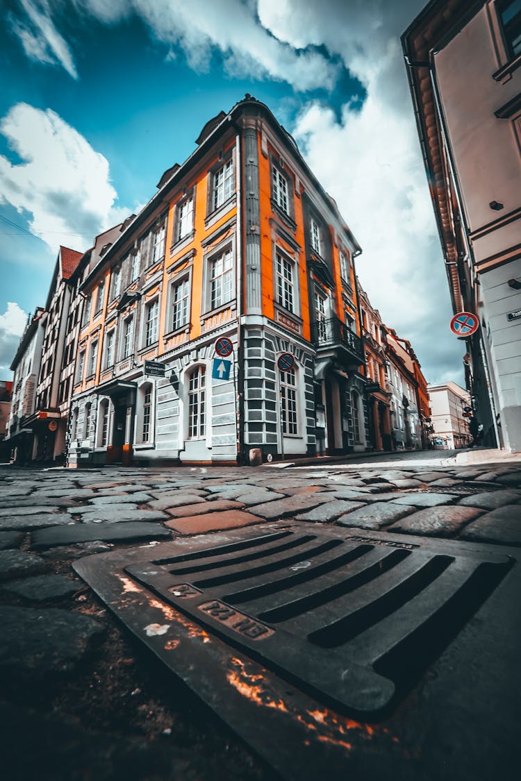 Old Building Facade On City Street Under Cloudy Sky