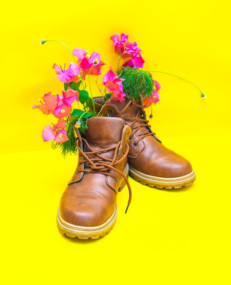 Modern Leather Boots With Decorative Flowers On Yellow Background