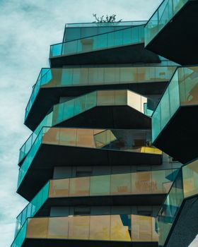 Unique architectural glass structure reflecting the sky in Paris, France.