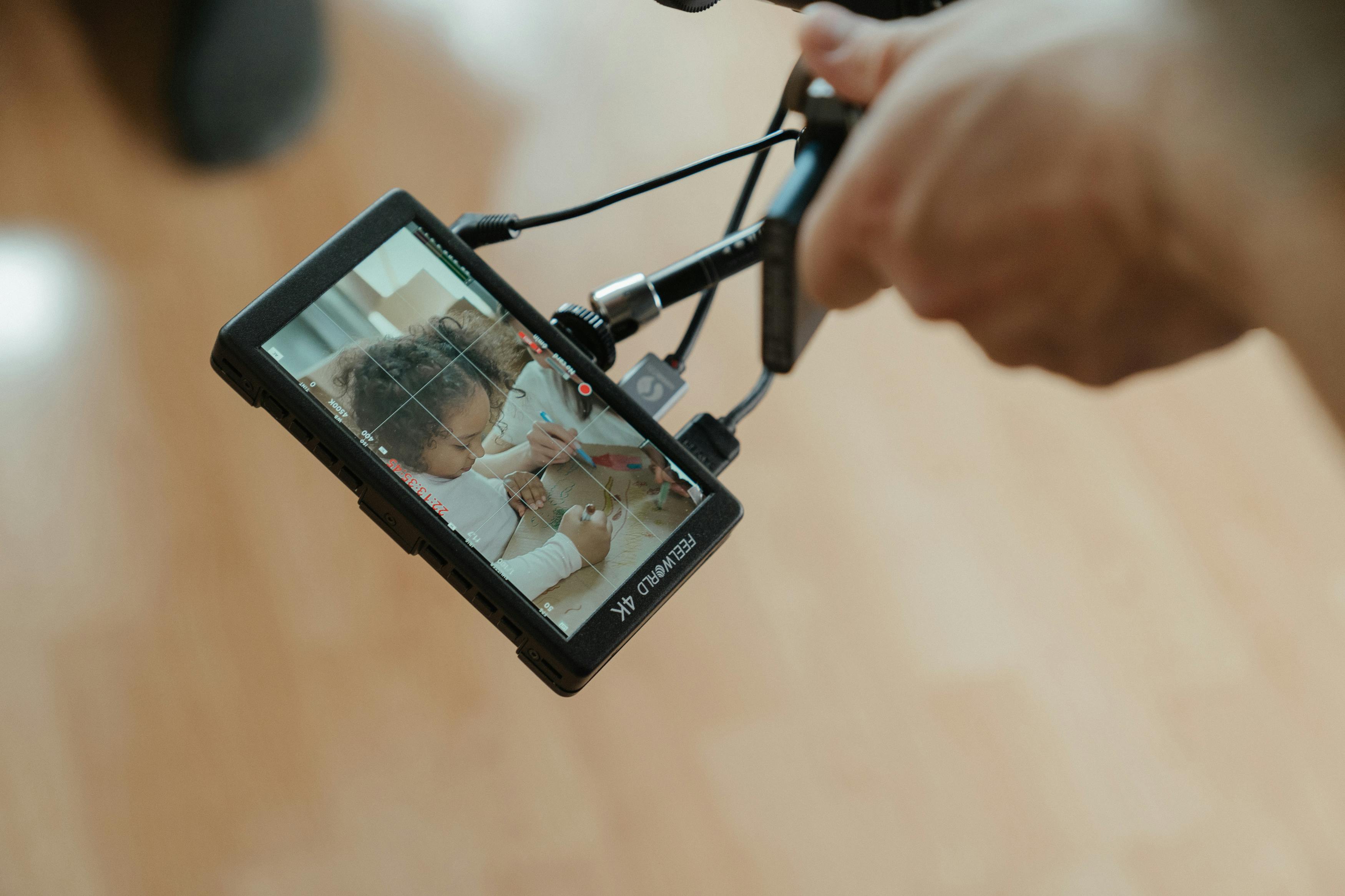 Person Holding Black Camera Taking Picture of a Person · Free Stock Photo