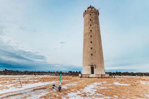 Grotta Lighthouse stands tall amidst the snowy landscape near Reykjavik, Iceland.