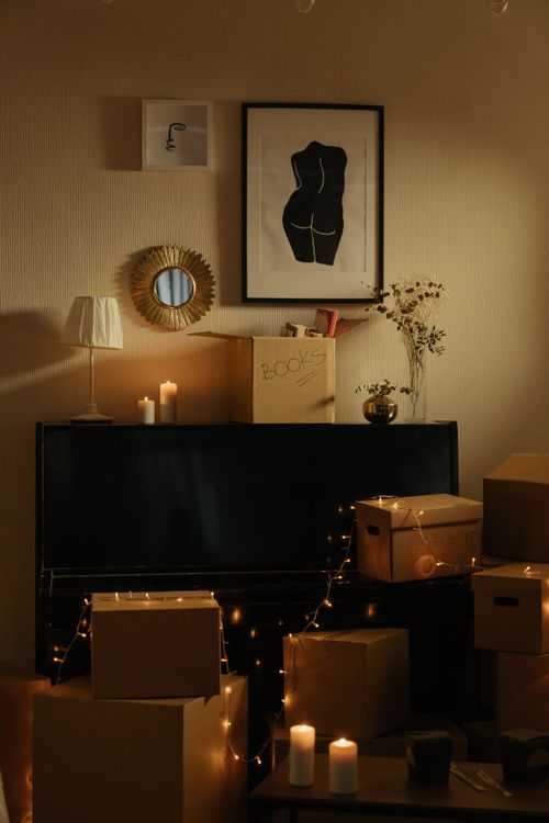 Free A warm, romantic room with candles, boxes, and elegant decor. Stock Photo