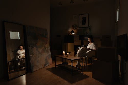 Woman reading Book on her New Apartment 