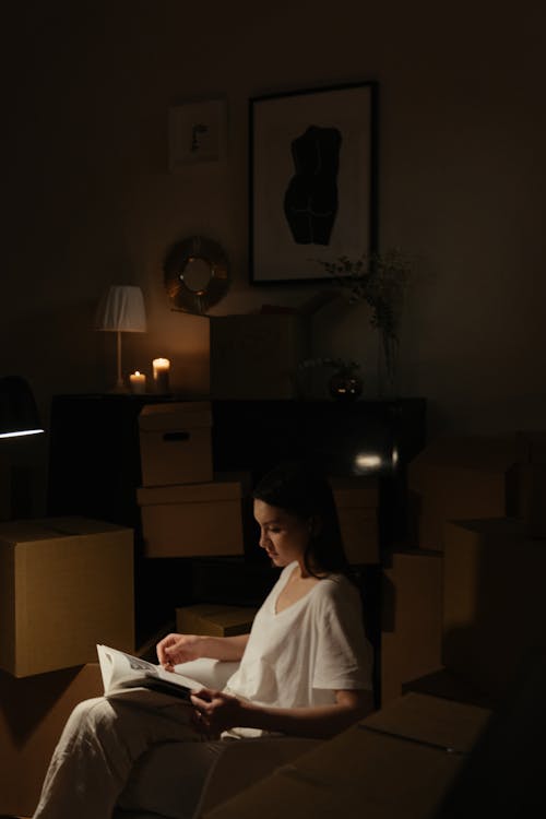 Woman in White Shirt Sitting on Chair