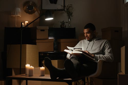 Man in Gray Dress Shirt Sitting on Black Leather Armchair