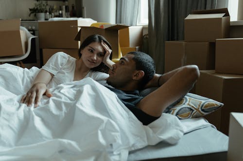 Man in White Shirt Lying on Bed