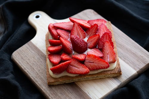 Free Sliced Strawberries over Squared Bread on Wooden Tray Stock Photo