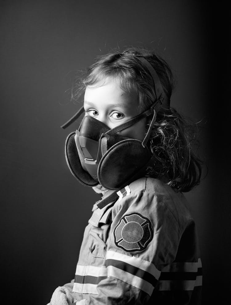 Grayscale Photo Of A Girl Wearing Gas Mask