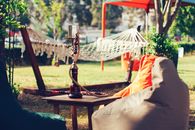 Hookah on Table beside Puff Chairs