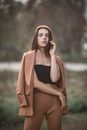 Alluring young lady resting in autumn countryside