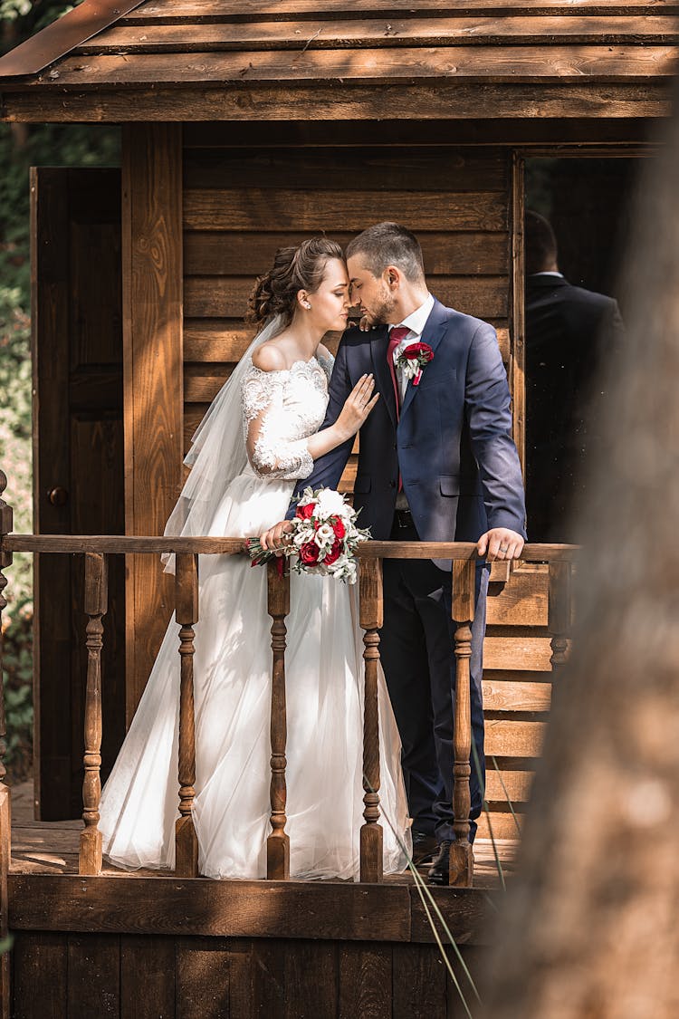 Elegant Newlyweds Hugging On Terrace Of Wooden House