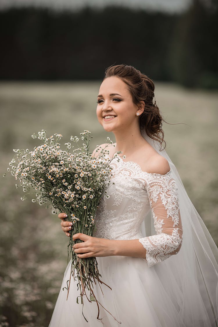 Beautiful Bride With Bouquet Of Wild Flowers
